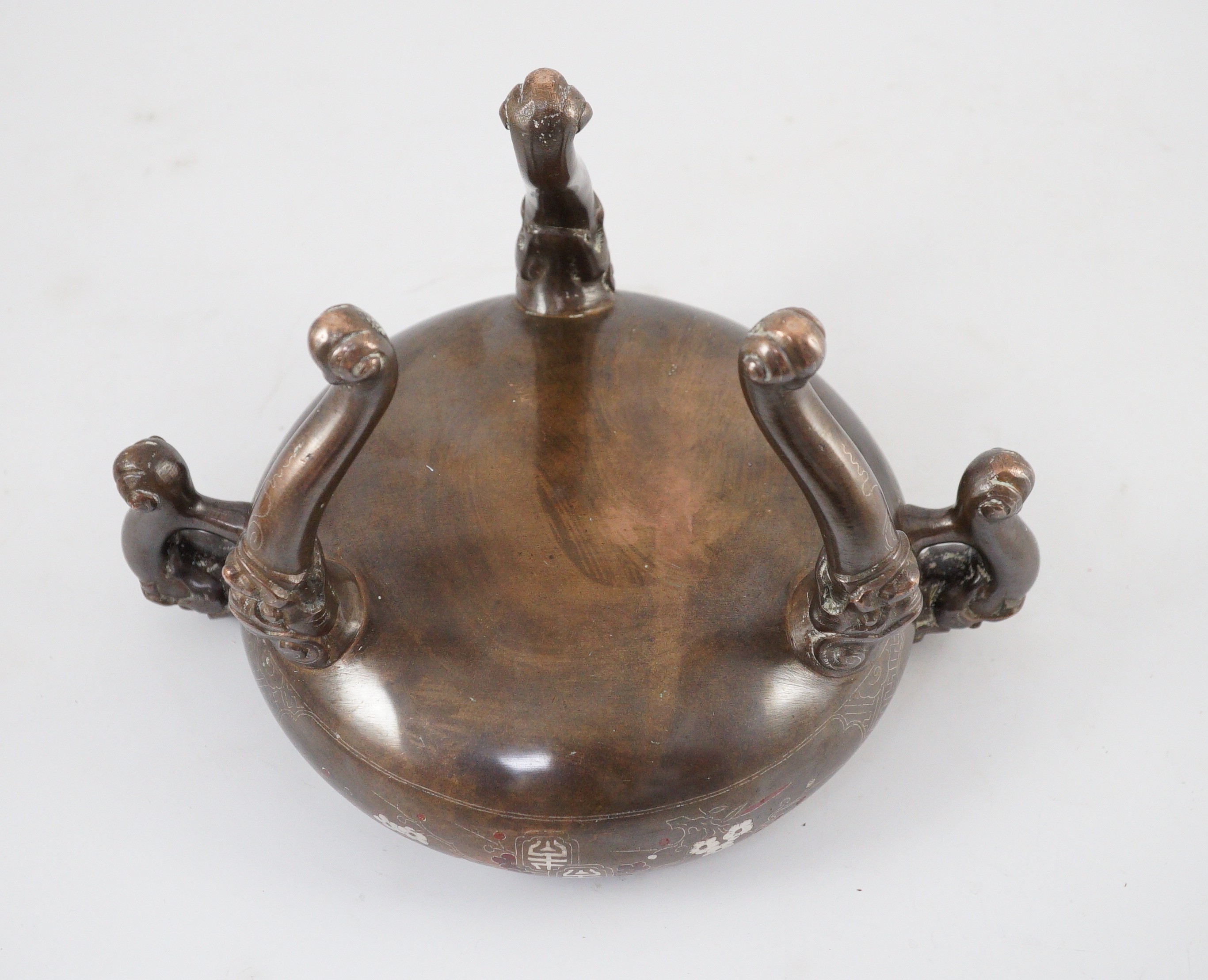 A Vietnamese silver inlaid bronze tripod censer and cover, 19th century, 24cm high, 24cm wide